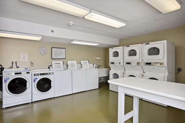 washroom featuring washing machine and dryer and stacked washing maching and dryer