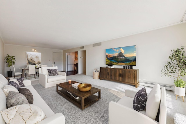 carpeted living room featuring baseboard heating