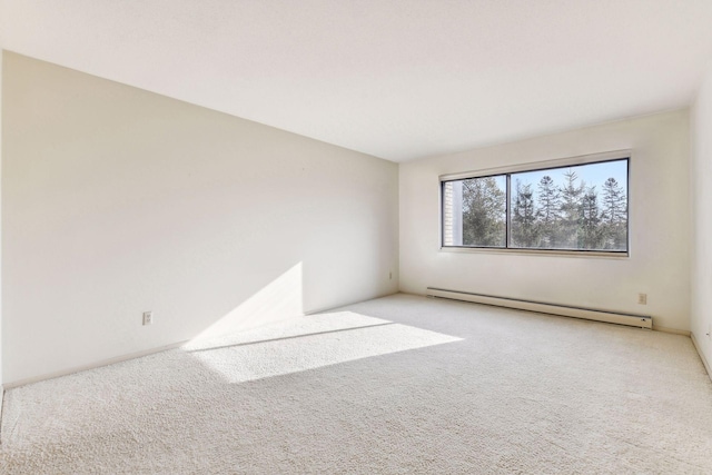 spare room featuring carpet floors and baseboard heating