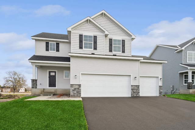 view of front of house with a front yard and a garage