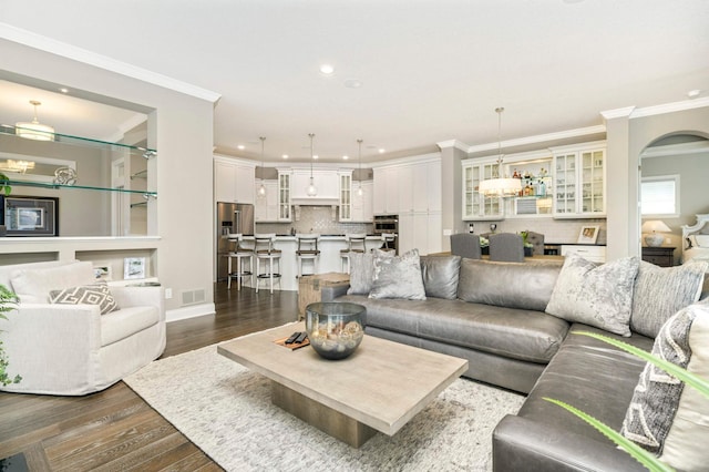 living room featuring dark hardwood / wood-style flooring and crown molding