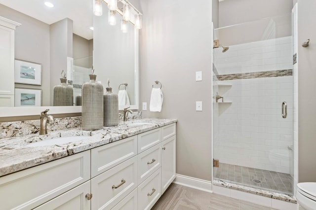 bathroom with vanity, toilet, and walk in shower