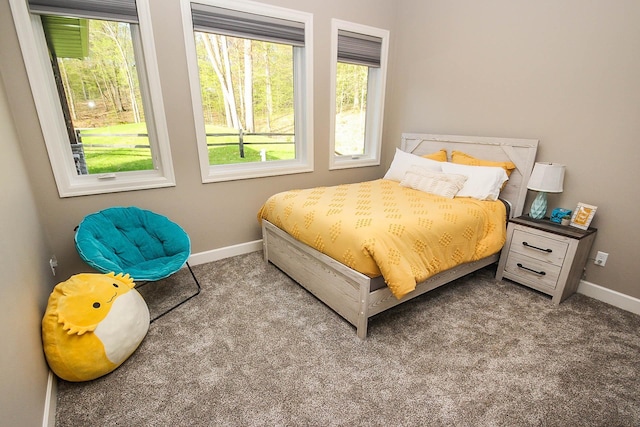 carpeted bedroom featuring multiple windows