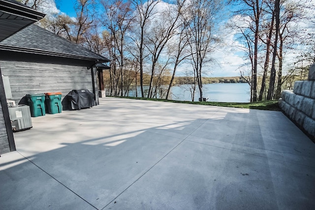 view of patio featuring area for grilling and a water view