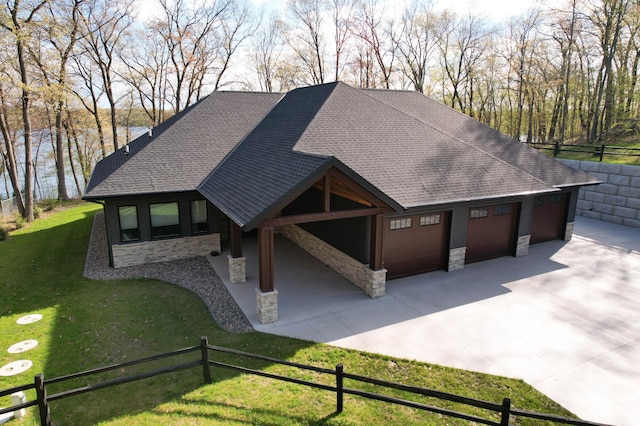 view of home's community featuring a garage, a lawn, fence, and concrete driveway