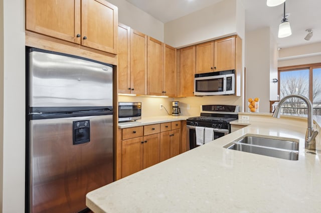 kitchen featuring pendant lighting, sink, and stainless steel appliances