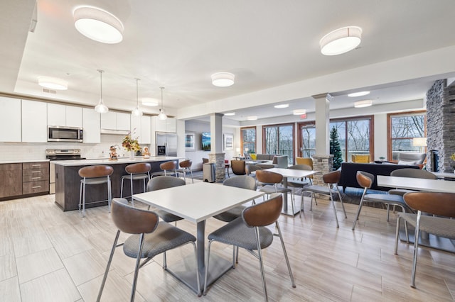 dining area with decorative columns and visible vents