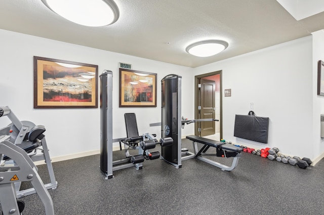 workout area featuring a textured ceiling