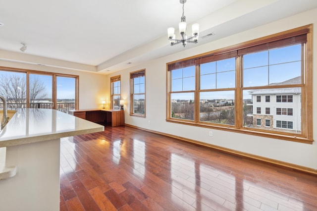 interior space with a chandelier and dark hardwood / wood-style floors