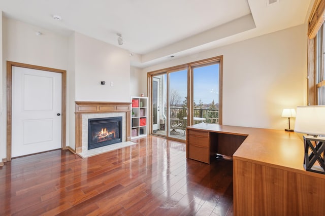 office space featuring a premium fireplace and dark hardwood / wood-style flooring