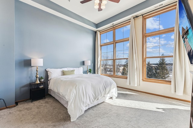 carpeted bedroom featuring a ceiling fan and baseboards