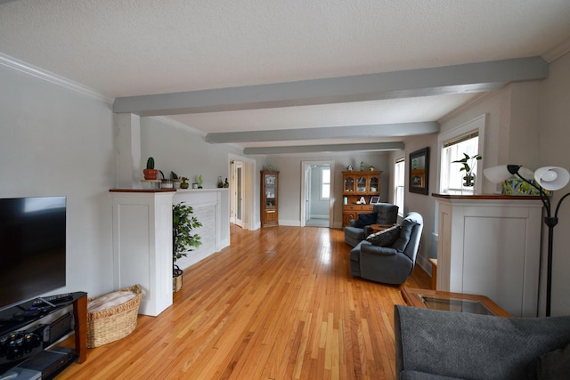 living room with light wood-type flooring, a textured ceiling, and beamed ceiling