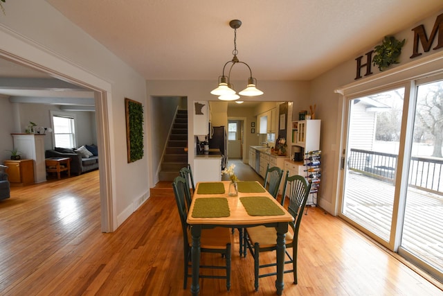 dining area with sink and light wood-type flooring