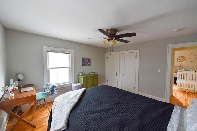 bedroom with ceiling fan and wood-type flooring