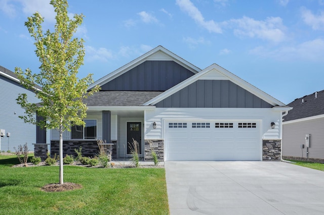 craftsman inspired home with a garage and a front lawn