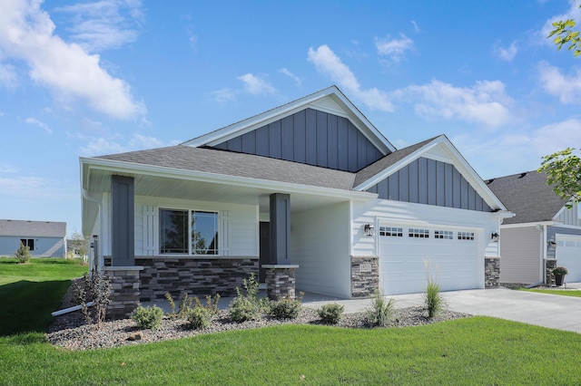 view of front facade with a front yard, a porch, and a garage