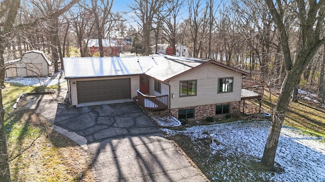 view of front facade with a garage and a wooden deck