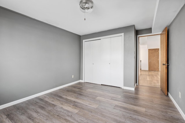 unfurnished bedroom featuring a closet and light hardwood / wood-style flooring