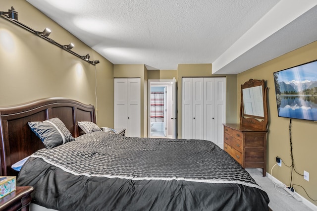 carpeted bedroom featuring a textured ceiling