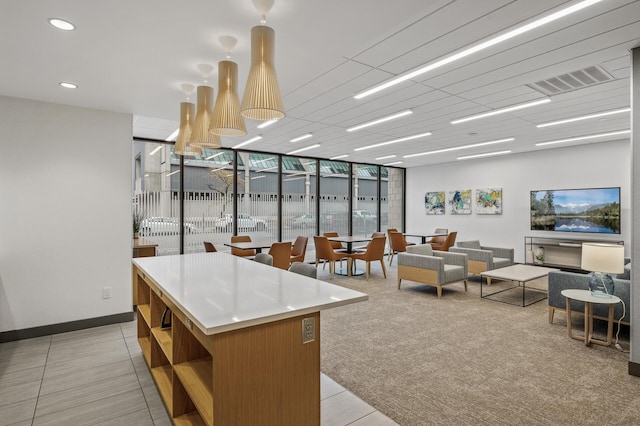 kitchen featuring light carpet, a center island, and floor to ceiling windows