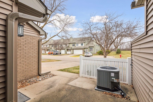 view of patio featuring central AC and a garage