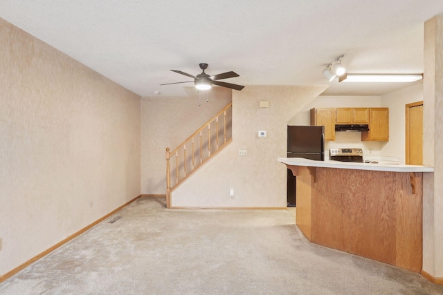 kitchen featuring stainless steel range with electric cooktop, light carpet, black refrigerator, ceiling fan, and kitchen peninsula