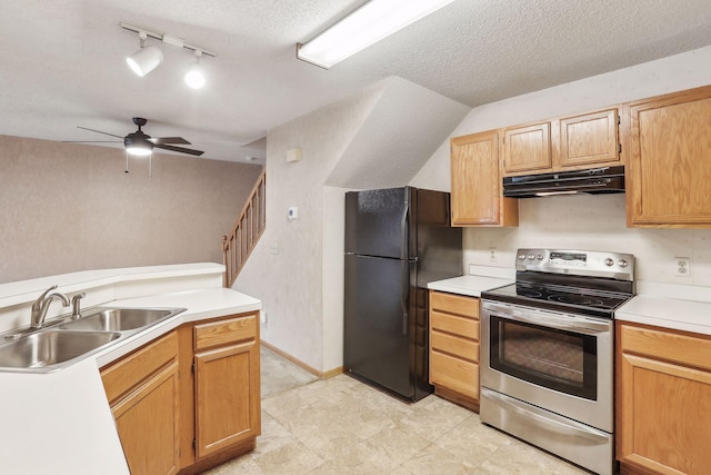 kitchen with black refrigerator, stainless steel range with electric cooktop, a textured ceiling, and sink