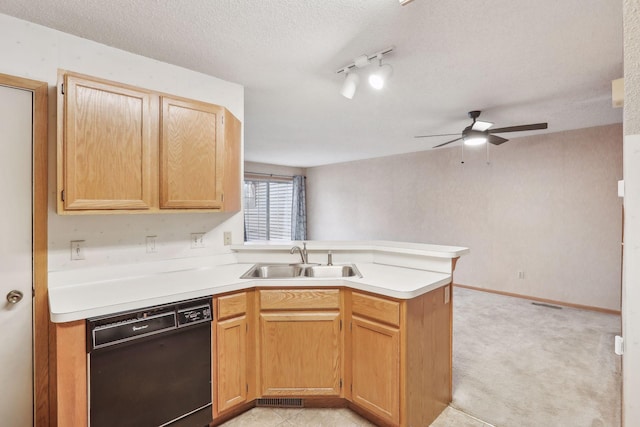 kitchen with dishwasher, sink, ceiling fan, a textured ceiling, and kitchen peninsula