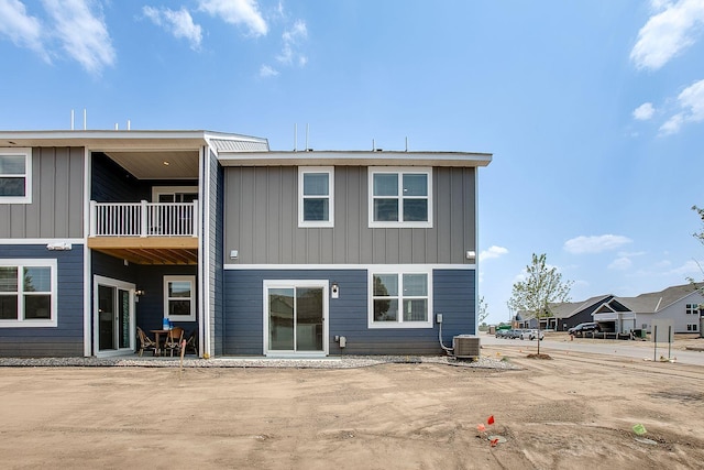 back of property with a patio area and a balcony