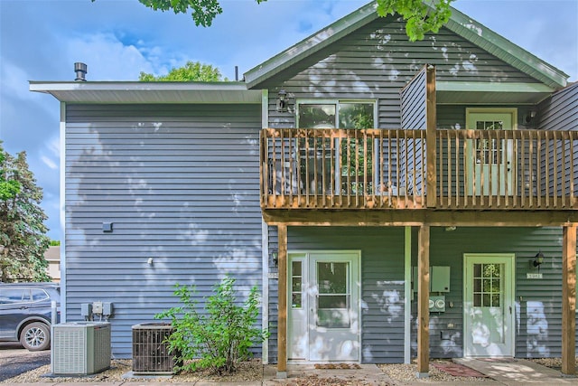 back of house featuring a balcony and central AC