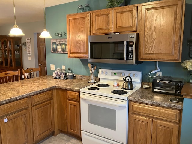 kitchen with white range with electric cooktop, light tile patterned floors, and hanging light fixtures