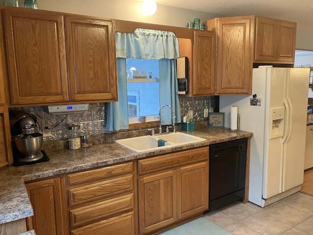 kitchen with decorative backsplash, sink, white refrigerator with ice dispenser, black dishwasher, and light tile patterned flooring