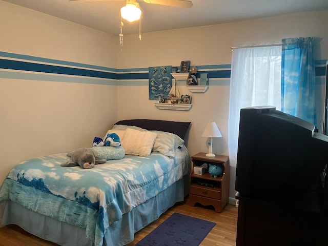 bedroom with hardwood / wood-style floors and ceiling fan