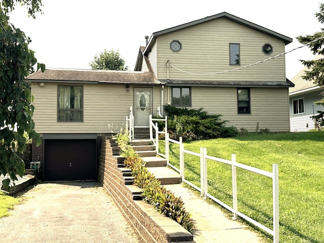 view of front of house featuring a garage and a front lawn