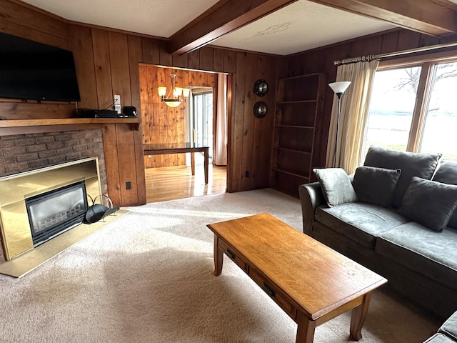 carpeted living room featuring wood walls, beam ceiling, and a fireplace