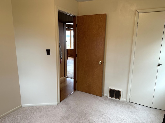 unfurnished bedroom featuring light carpet