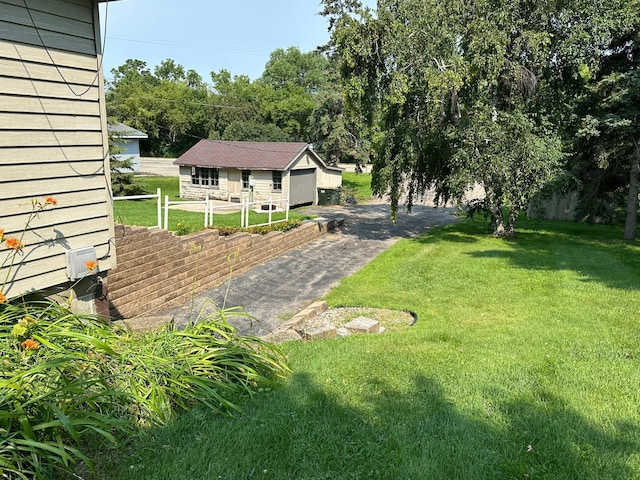 view of yard with fence and a garage