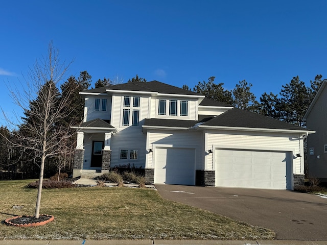 view of front facade with a front lawn and a garage