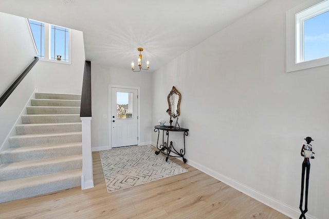 foyer entrance featuring a notable chandelier and light hardwood / wood-style floors