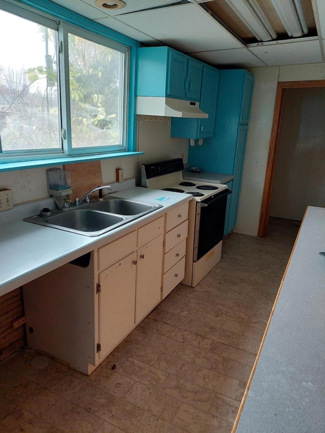 kitchen featuring a paneled ceiling, sink, blue cabinetry, electric range, and white cabinets