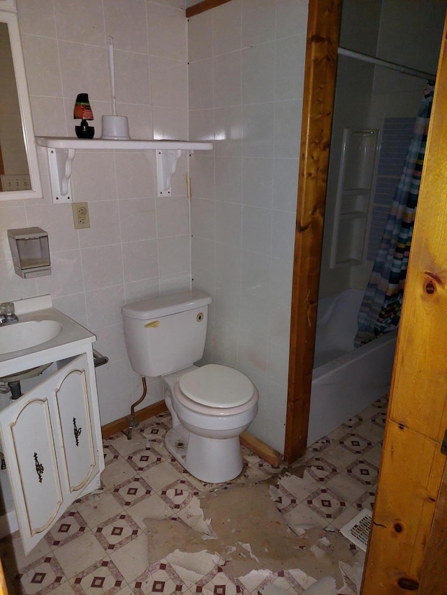 full bathroom featuring vanity, toilet, tile walls, and shower / tub combo with curtain