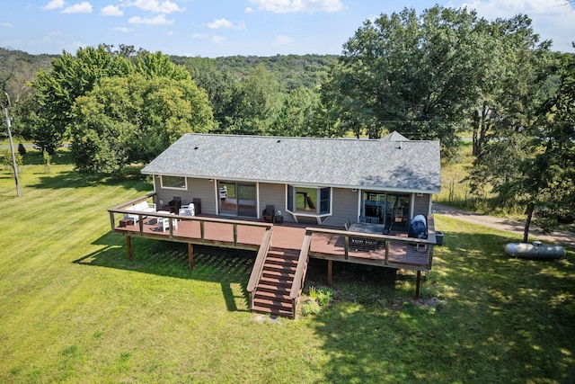 back of property featuring a deck and a yard