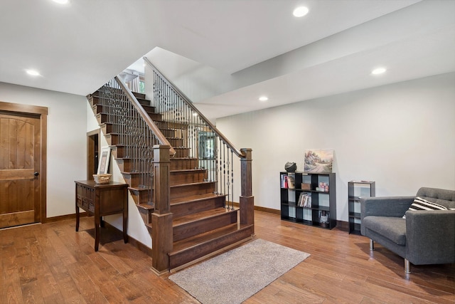 staircase with hardwood / wood-style floors