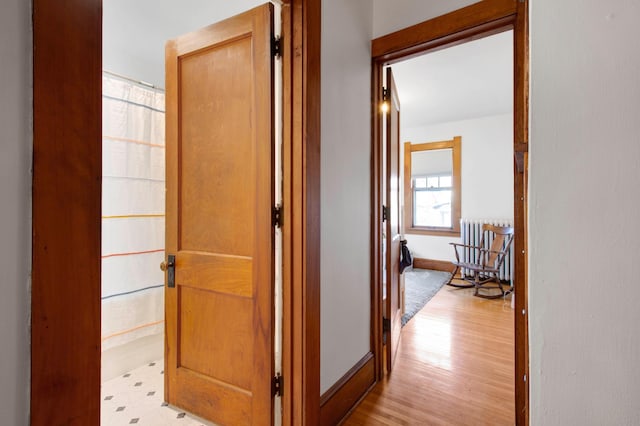 hall featuring radiator heating unit and light wood-type flooring