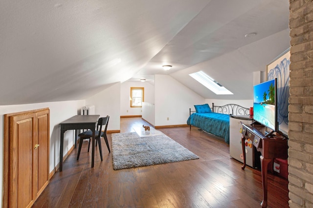 bedroom with vaulted ceiling with skylight and dark wood-type flooring