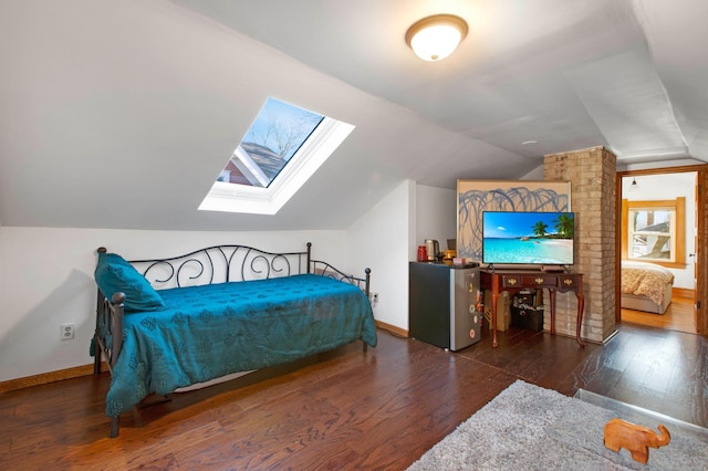 bedroom featuring vaulted ceiling with skylight and dark wood-type flooring