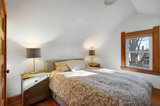 bedroom featuring dark hardwood / wood-style floors and vaulted ceiling