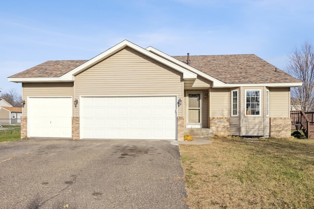 view of front of house with a garage and a front lawn