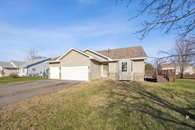 single story home with a front yard, a garage, and a deck