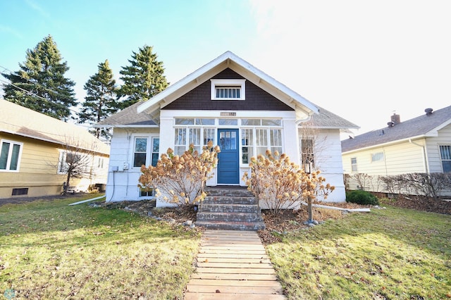 bungalow-style home featuring a front yard